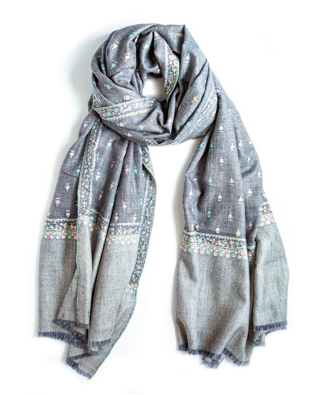 A gray scarf with delicate multicolor embroidered patterns and fringed edges, draped on a plain white background.